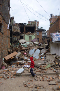 A boy stands in the rubble in the aftermath of the earthquake in Nepal. Image via BMS World Mission. 